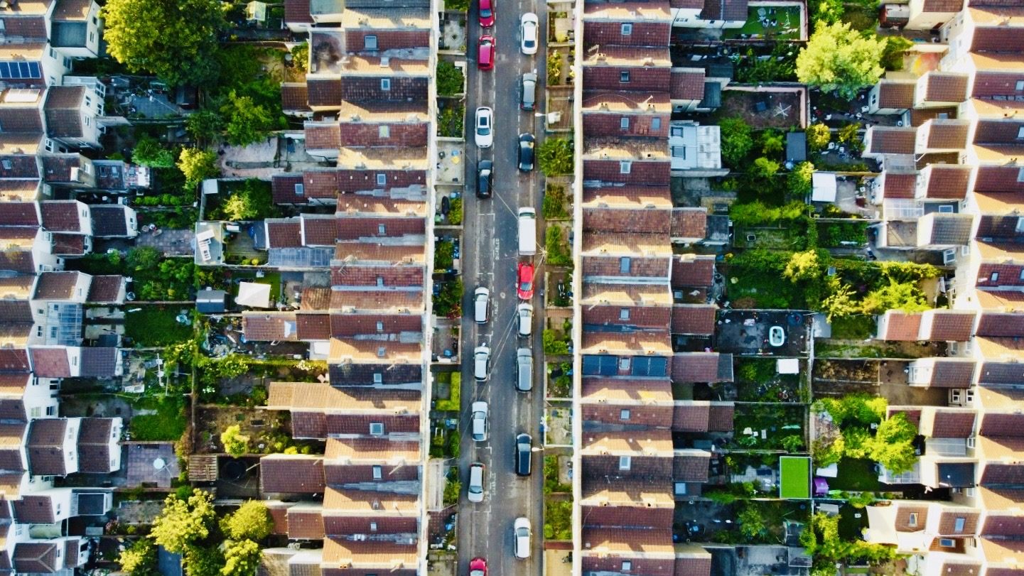 An aerial view looking down over the terraced streets of the St Jude's neighbourhood in the late-afternoon light.